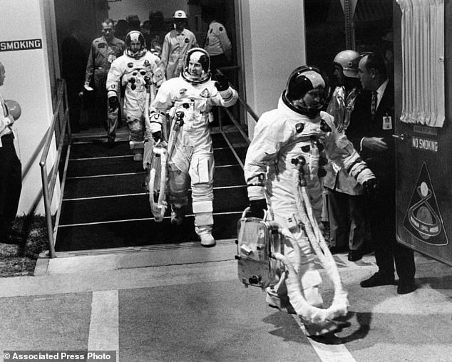 Apollo 8 astronauts, dressed and ready to go, walk to a van en route to their Saturn V rocket for their lunar orbit mission from Cape Kennedy, Florida, December 21, 1968. Leading the way is Commander Frank Borman