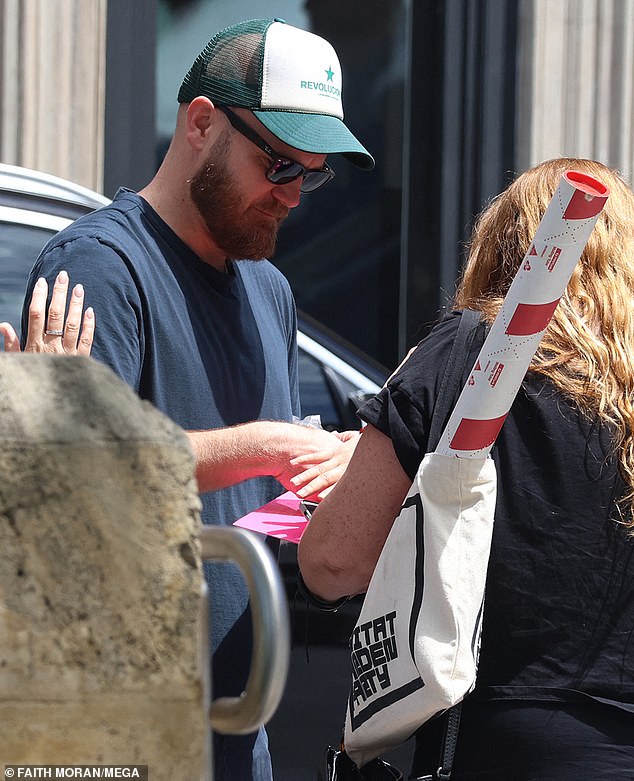 The British-born musician pulled off a smart-casual look in a navy blue T-shirt, jeans and white sneakers.  He completed his outfit with a Revolution baseball cap and accessorized with stylish sunglasses