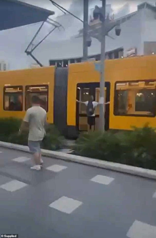 Two teenagers were involved in a wild moment on board the Gold Coast light rail (pictured) as they clung to the outer doors of the moving tram