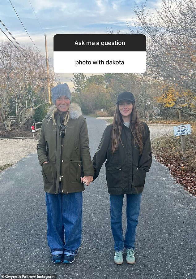 Gwyneth Paltrow lovingly held hands with her ex-husband Chris Martin's partner, Dakota Johnson, in a new photo this week