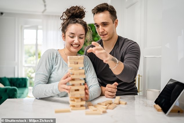 Whether it's a game of Jenga or a round of mini golf, many date nights are centered around a competition.  Now a study has shown that when it comes to these competitions, the old adage of 'happy wife, happy life' really does ring true (stock image)