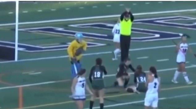 The injured player immediately falls to the ground in pain after suffering serious facial injuries, including missing two teeth