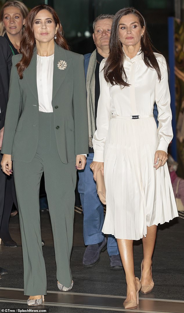 Crown Princess Mary of Denmark (pictured left) put on a brave display as she received Queen Letizia (pictured right) and her husband on the third day of their state visit to Denmark