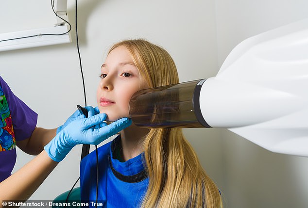 Wearing a lead apron during a dental x-ray can hinder obtaining a clear view of the jaw, especially if it has a collar, necessitating a second try - doubling the total dose