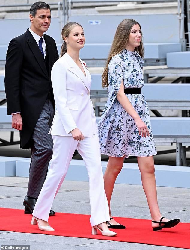 Birthday girl Princess Leonor of Spain, 18, walks with her 16-year-old sister Infanta Sofia on their way to a solemn ceremony in which Leonor swears allegiance to the Spanish constitution.  Sofia is also loyal and wears flat shoes to ensure she doesn't overshadow the older sister, who becomes queen