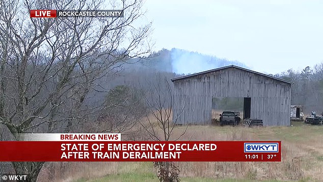 Smoke can be seen behind a barn near Livingston, Kentucky, on Wednesday after a train derailed and caught fire