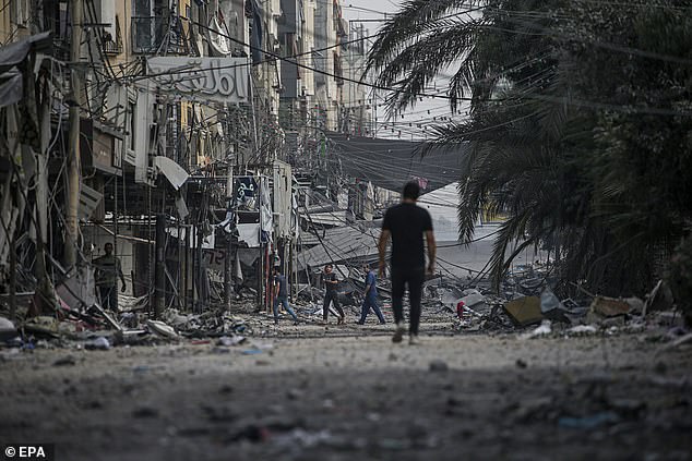 A Palestinian walks among the rubble after an Israeli airstrike in the Al Sheikh Redwan neighborhood in northern Gaza City on Tuesday