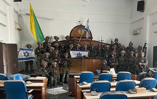 One photo showed troops posing with guns and Israeli flags in a room of the Palestinian Legislative Council building in Gaza City.
