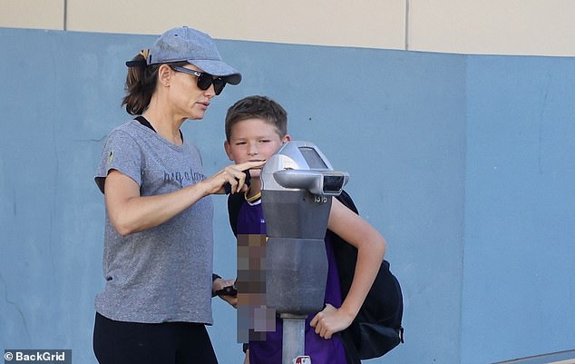 Practical: The mother of three, whom she shares with ex-husband Ben Affleck, gave her son a lesson in the rules and regulations of parking meters, which can be tricky