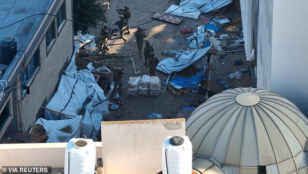 Israeli soldiers walk through the Al Shifa hospital complex amid their ground operation against Hamas in this still image from the distribution video obtained on November 15, 2023