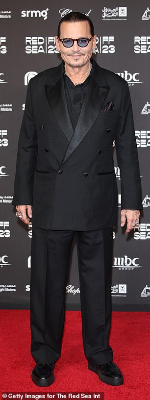 The star, 60, donned an all-black suit for the event as he posed for the red carpet