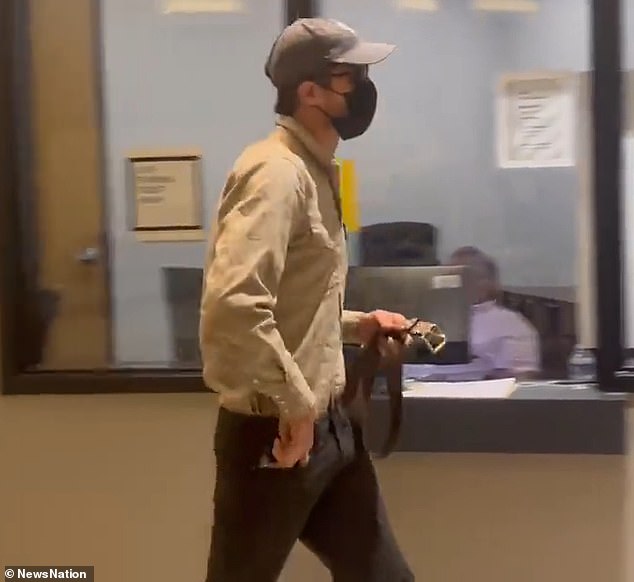 Colin Strickland walks into court Monday wearing a mask, sunglasses and hat to continue his testimony against ex-girlfriend Kaitlin Armstrong