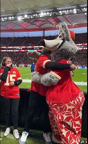 The supporter first hugged the wolf mascot and then his new fiancée