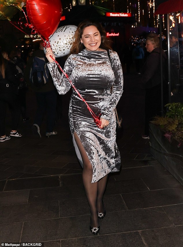 Birthday girl: Kelly Brook, 44, looked in good spirits on Thursday as she left Global Studios with a handful of birthday balloons