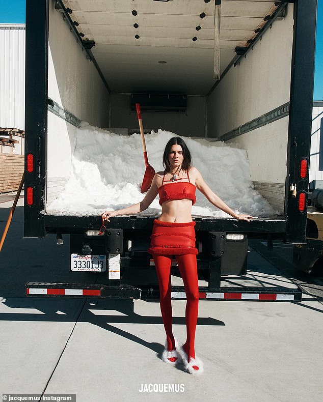 Red hot: Kendall Jenner sizzled in new photos from Jacquemus' holiday campaign.  The 28-year-old model was red hot in a crimson, fur-lined crop top paired with the matching low-cut miniskirt as she posed in front of a semi-truck full of snow.