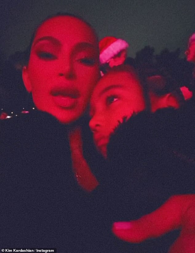 Holiday spirit: Kim Kardashian got into the holiday spirit on Friday when she attended Mariah Carey's Merry Christmas One And All!  show at the Hollywood Bowl with her daughters