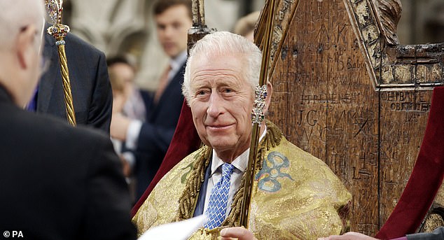 His Majesty's suit can be seen peeking out from under his robes as he sits on the Coronation Chair in Westminster Abbey in BBC One's Charles III: The Coronation Year