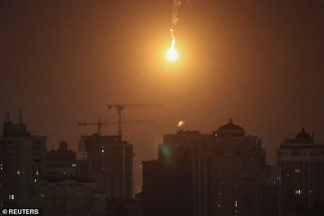 A drone explosion is seen in the sky above the city during a Russian drone strike