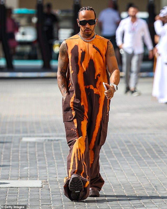 Unique: Lewis Hamilton, 38, showed off his quirky sense of style again in an orange and brown tie-dye all-in-one ahead of Saturday's Abu Dhabi Grand Prix