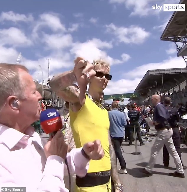 Cringe: Machine Gun Kelly left fans cringing after storming away from Sky Sports' Martin Brundle during excruciatingly awkward interview at the Brazilian Grand Prix