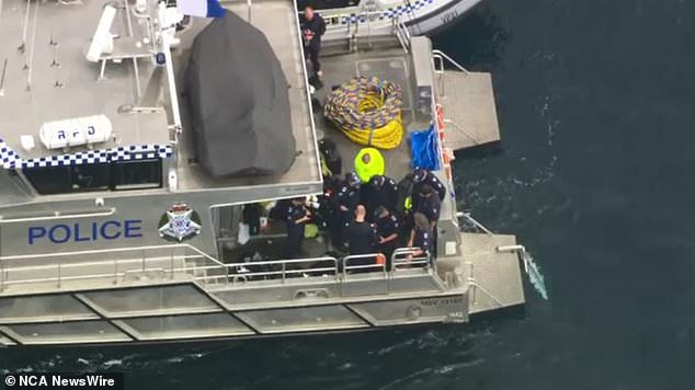 The wreckage of a former military fighter jet that crashed into Melbourne's coast with two people on board has been found.  A police boat is depicted