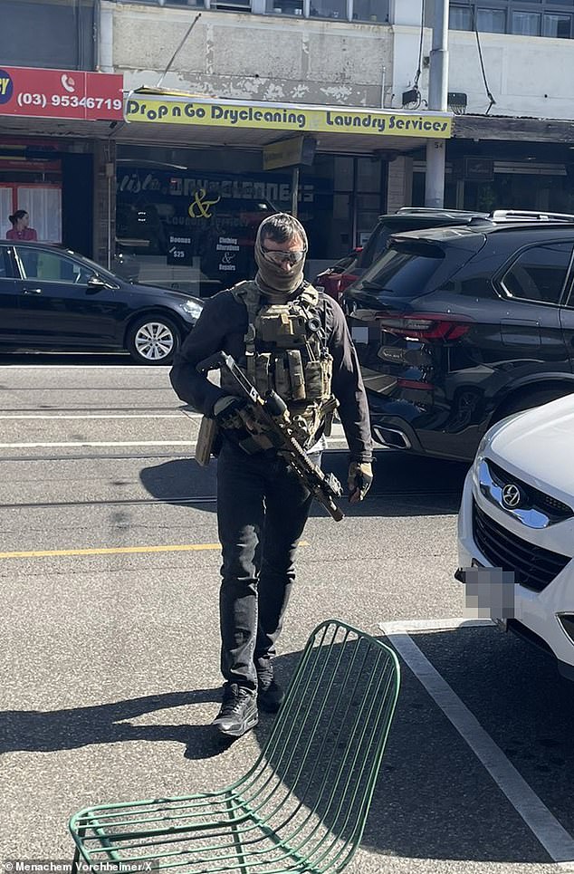 One officer was seen at the scene wearing a bulletproof camouflage vest and a balaclava while wielding an AR-15 (photo)