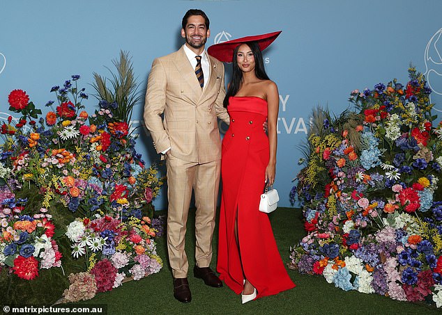 His dark brown hair was elegantly styled, he had a shaggy beard and he kept his arm tenderly wrapped around Evelyn's waist as they posed for photos.