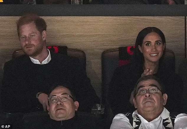 The mother of two smiled as she watched the first period of NHL hockey next to Prince Harry