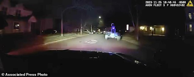 In this image taken from Ann Arbor Police video, a patrol car chases a stolen forklift driving through the streets of Ann Arbor, Michigan, Saturday, November 25, 2023. Police say the forklift was driven by a 12-year-old boy