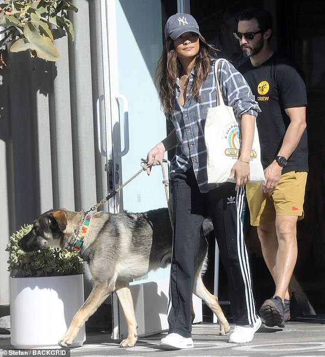 Taking it easy: The artist, who secretly tied the knot earlier this year, opted for a black t-shirt and yellow shorts as he spent time with his wife