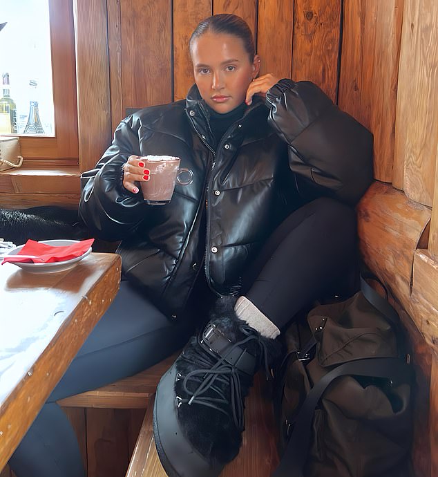 Cozy: Molly-Mae stunned in a quilted jacket and kept warm with hot chocolate in an Instagram post on Friday while on holiday in the Alps