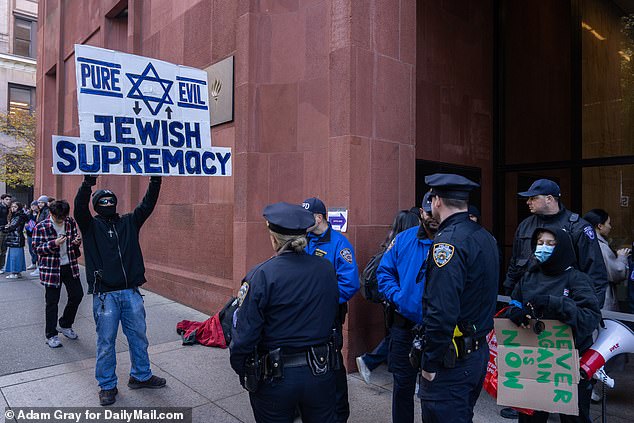 One photo showed the protester being kept away from the main protest by police officers