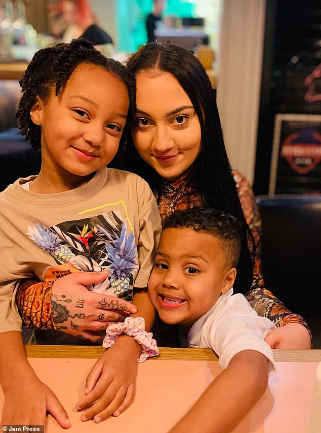 Courtney Gibbons pictured (center) with her children Ariah (left) and Kamiy (right), thinking she was 'too young' to get cervical cancer