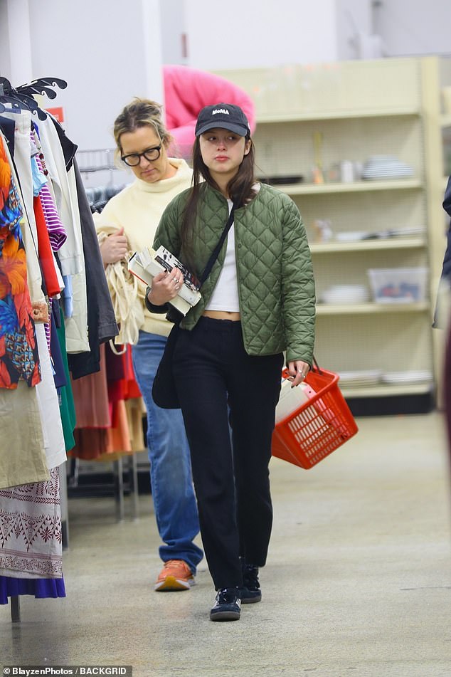 Mother-daughter outing: Olivia Rodrigo was spotted thrift shopping in New York City on Friday.  The 20-year-old singer, dressed in a green puffer jacket, joined her mother, Jennifer, to pick out some books at the local Salvation Army library during a day out.