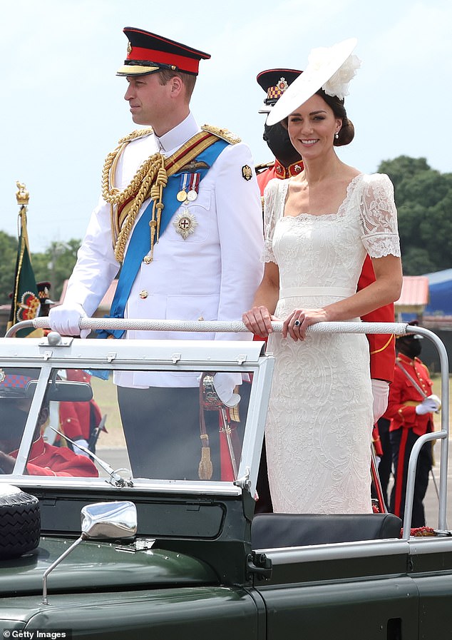 The Duke and Duchess of Wales (pictured) rode standing in an open-top Land Rover during the Commissioning Parade in Jamaica