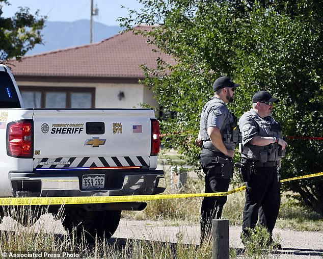 Fremont County deputies monitor the road leading to Return to Nature Funeral Home in Penrose, Colorado, Thursday, October 5, 2023