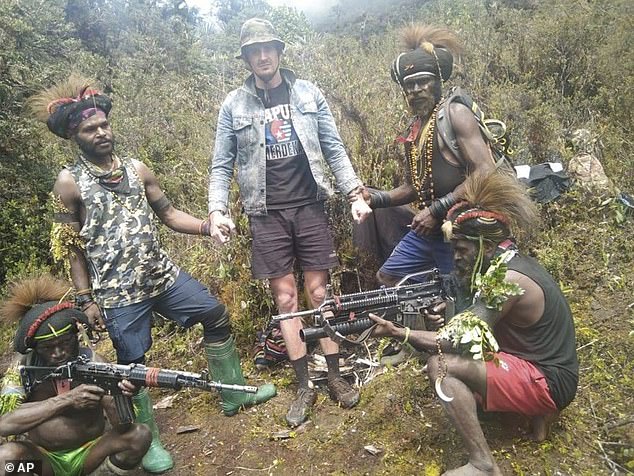 Photo: Philip Mehrtens, center, is seen with fighters from the West Papau Liberation Army