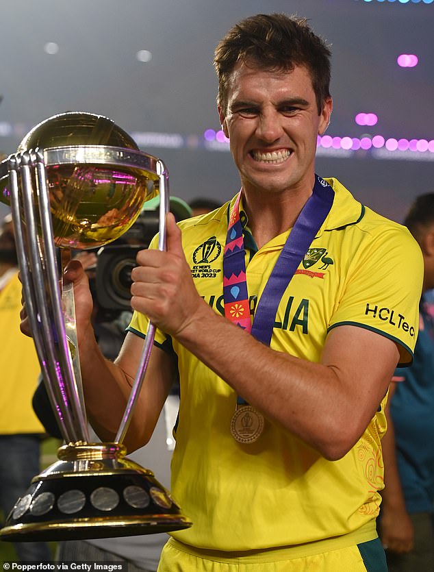 Cummins (pictured celebrating with World Cup trophy) applauds coach Andrew McDonald's brave decision to keep Travis Head in the squad after he broke his hand