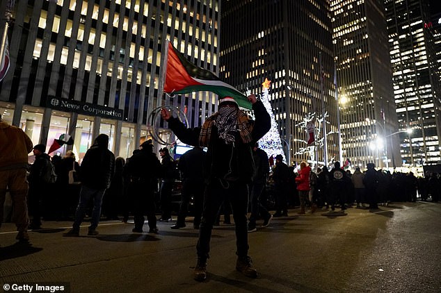 Pro-Palestinian supporters gather for a rally near the Rockefeller tree lighting in New York City on Wednesday
