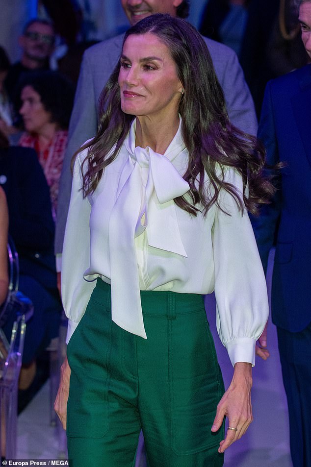 For the outing, mother-of-two Letizia's stylish ensemble consisted of a white collared blouse and tie, as well as high-waisted tailored trousers.