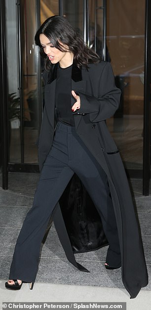 NYC cool: The actress stepped out in a black overcoat with matching pants and top