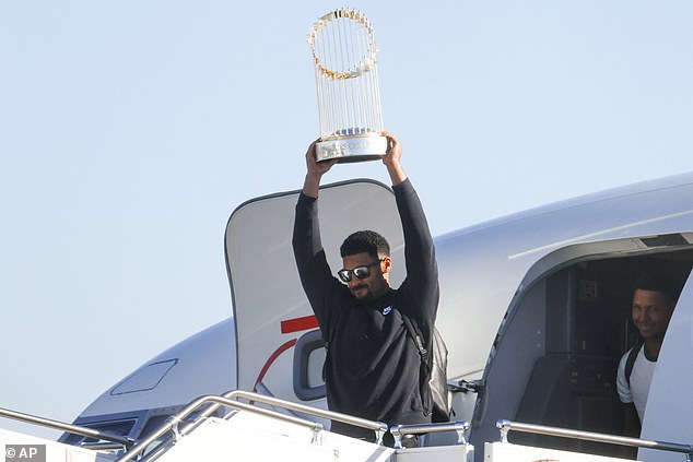 Marcus Semien hoisted the World Series trophy above his head on Friday morning