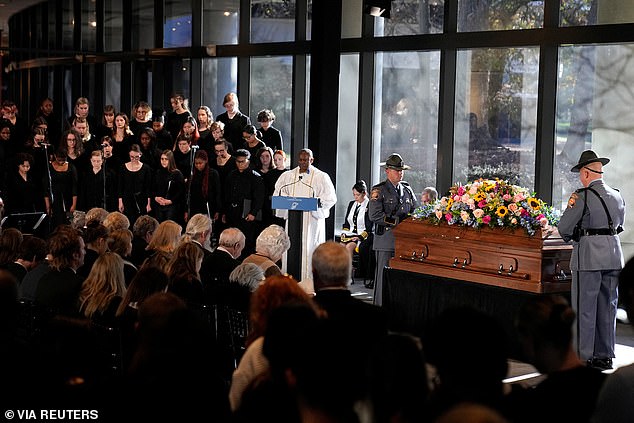 Mourners gather to hear the Rev. Tony Lowden speak as Rosalynn Carter's casket lies at rest at the Jimmy Carter Presidential Library on Monday, November 27, after he passed away on November 19 at the age of 96