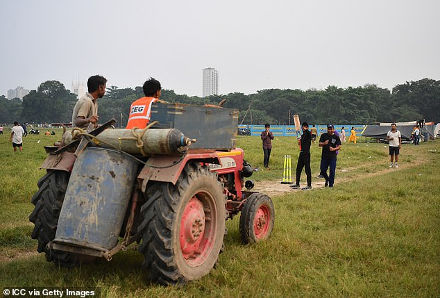 Tennis ball cricket faces unique challenges, such as pausing play to allow a tractor to cross the field (pictured)