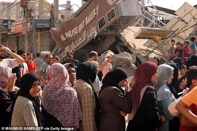 Can't win?  Meanwhile, Israel claimed that about 500 Hamas militant rockets were misfired and landed in Gaza, and it accuses the terrorist group of using civilians as human shields at targeted militant sites and infrastructure (Nuseirat refugee camp pictured Thursday)