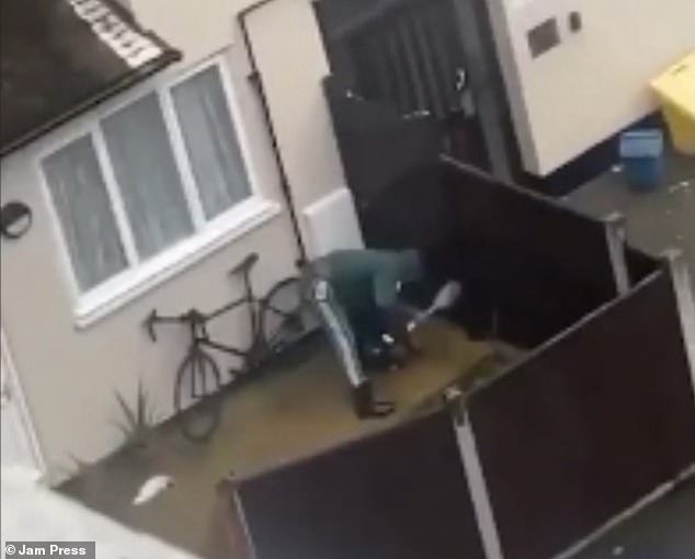 Shocking footage shows the moment a man repeatedly hits a dog over the head with a shovel