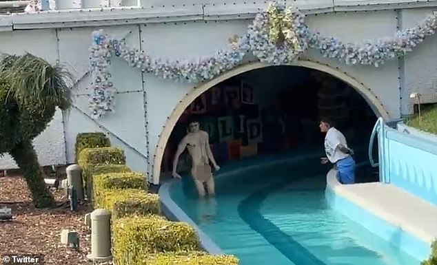 Bare Necessities: A Disney employee protests the visitor as he frolics naked in a rowing stream beneath one of the Magic Kingdom's exhibits