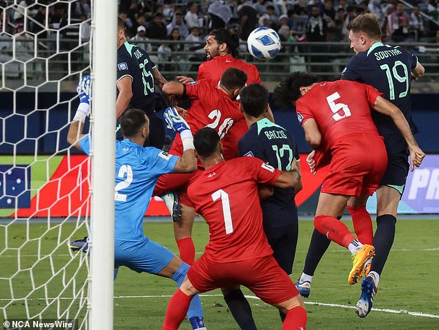 Harry Souttar (right) leads the Socceroos into the lead against Palestine.  Photo: Yasser Al-Zayyat / AFP