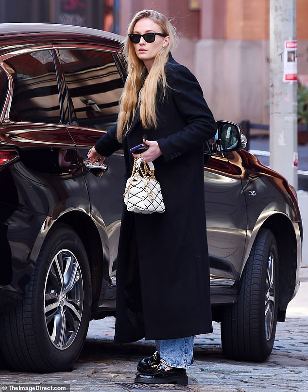 First sighting: Sophie Turner has been spotted for the first time since she was caught kissing aristocrat Peregrine Pearson in public in Paris on Saturday.  The Game Of Thrones star appeared to leave her New York City home and enter a waiting car