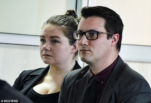 Nicholas Spencer and his wife, Mackenzie Leigh Mathias Spencer, sit in court as the verdict was read out in a Kampala court on Tuesday